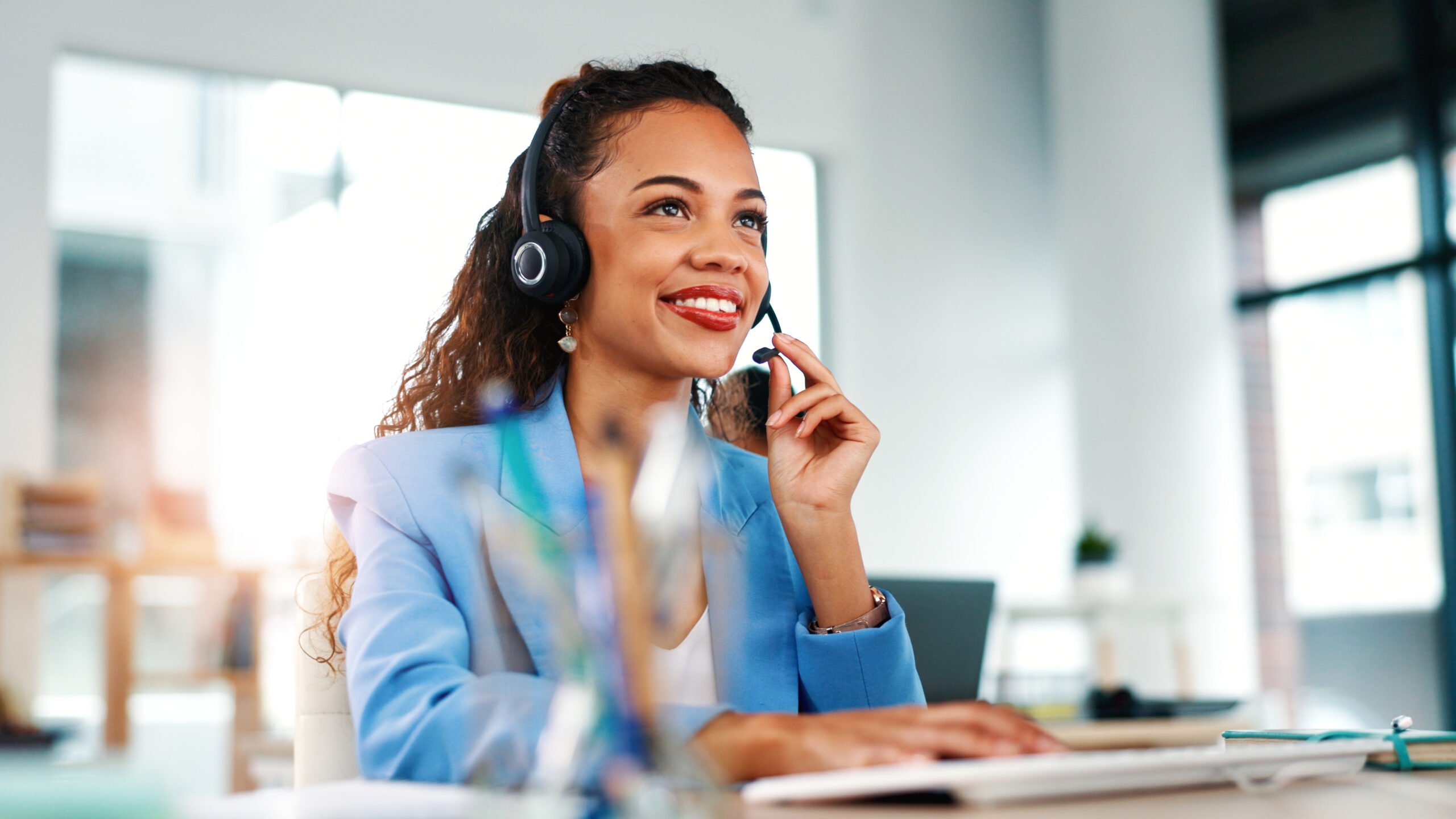 Headset, smile and businesswoman in office with communication, consultation or client engagement. Talk, mic and customer success manager with online support for crm, onboarding or helpdesk at agency.